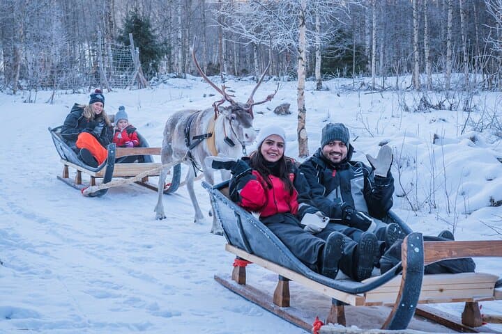 Guests on a long sleigh ride during StayLapland’s Kuoksa Reindeer Adventure in Rovaniemi.