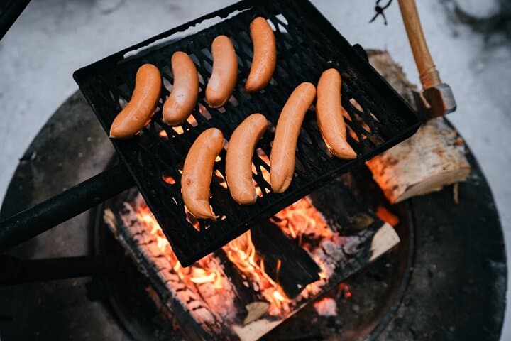 Grilling Finnish sausages over the campfire
