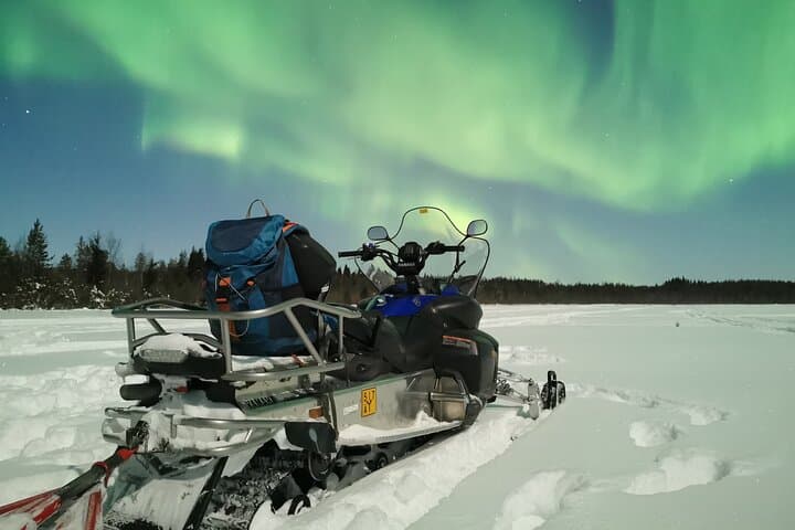 Northern lights safari by snowmobile