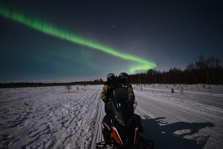 Arctic Aurora Chase by Snowmobile