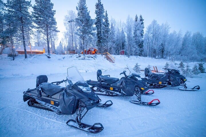 Snowmobiles parked outside our Riverside Lodge.
